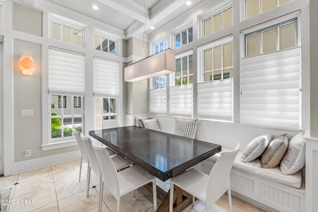 dining space with beam ceiling and crown molding