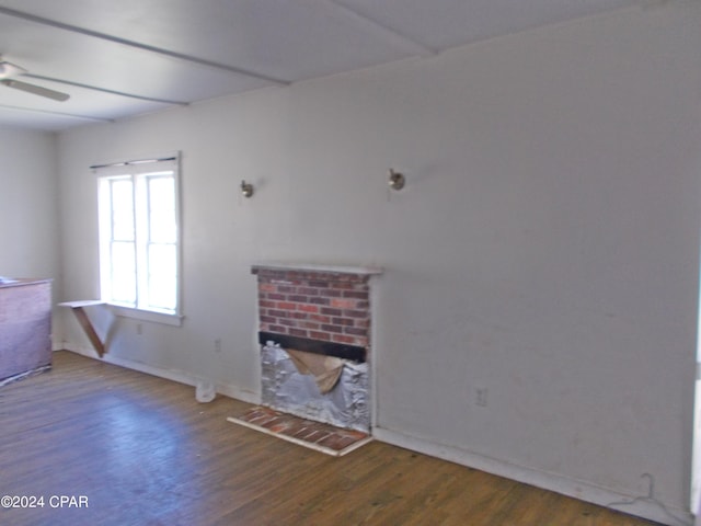 7949 Old Spanish Trl, Sneads, FL 32460 - unfurnished living room featuring wood finished floors, a brick fireplace, and a ceiling fan
