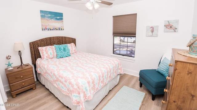 bedroom with light hardwood / wood-style flooring and ceiling fan