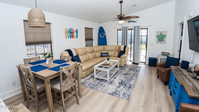 living room featuring light hardwood / wood-style flooring, vaulted ceiling, and ceiling fan