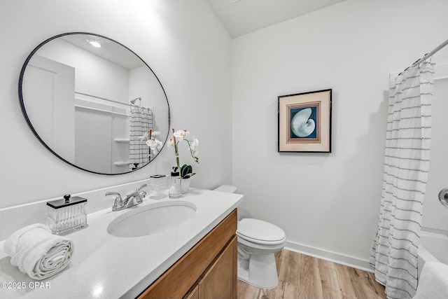 full bathroom featuring hardwood / wood-style flooring, vanity, shower / tub combo with curtain, and toilet