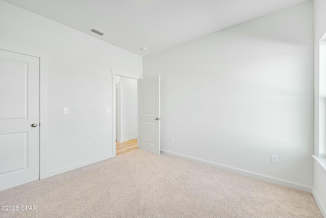 spare room with light colored carpet