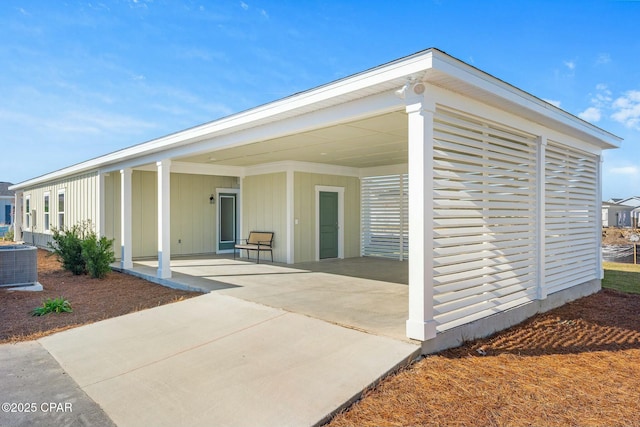 rear view of property with a carport and central air condition unit