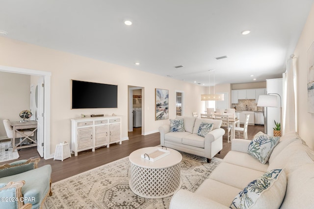 living room featuring hardwood / wood-style floors and washer / dryer