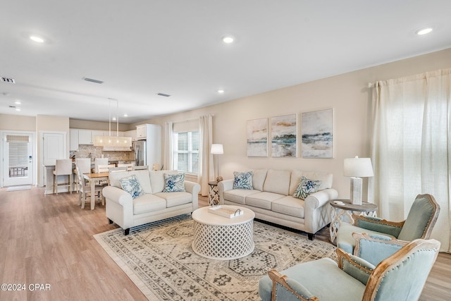 living room with light hardwood / wood-style flooring