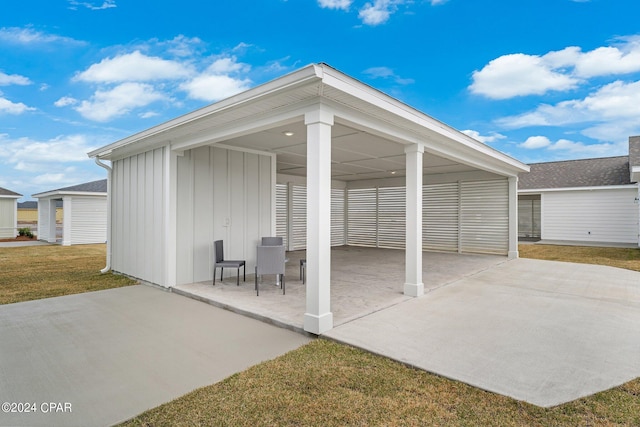 exterior space featuring a carport and a yard