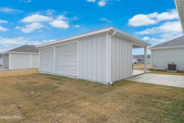 garage with cooling unit and a lawn