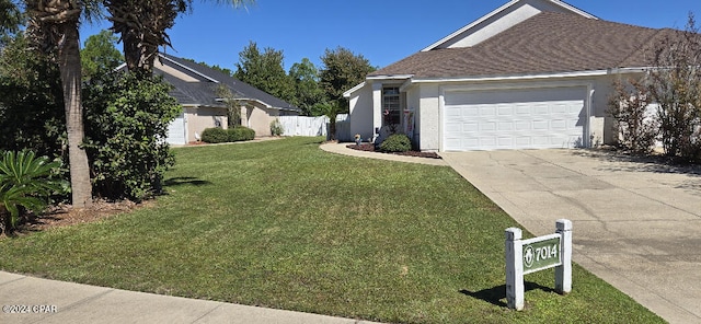 view of side of property with a garage and a lawn