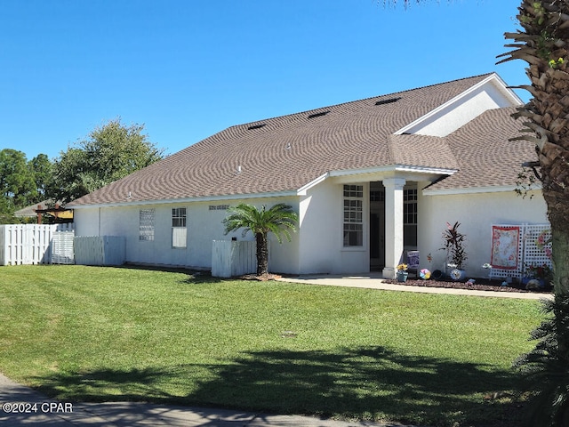 rear view of property with a yard