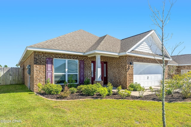 view of front of property with a front lawn and a garage