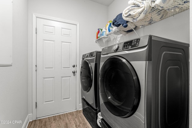 laundry area featuring washer and dryer and wood-type flooring