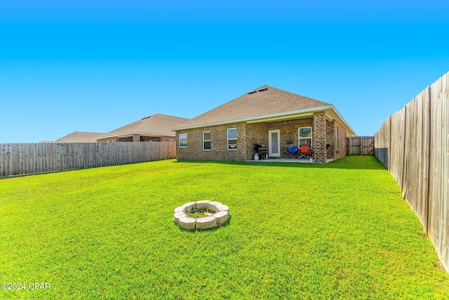 rear view of property with a yard and a patio area