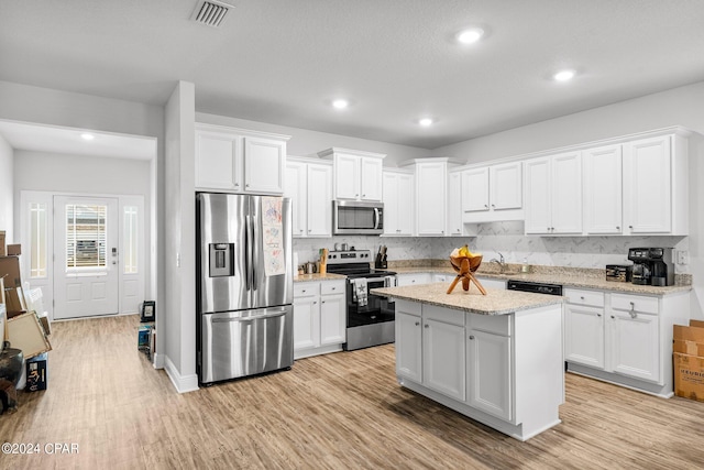 kitchen featuring appliances with stainless steel finishes, light wood-type flooring, and white cabinets