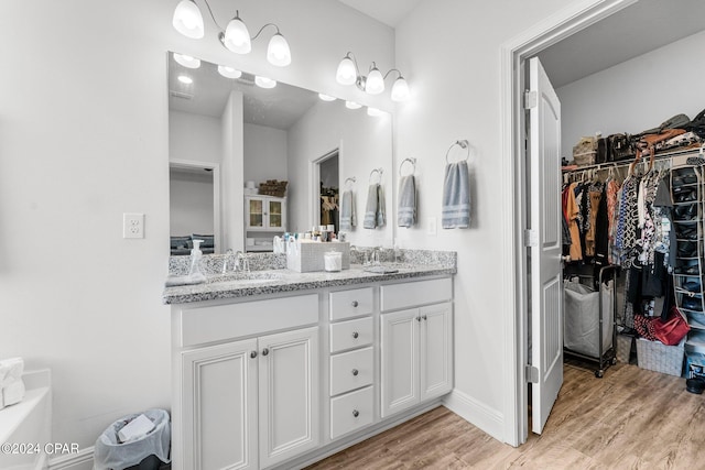 bedroom with ensuite bath, crown molding, a tray ceiling, and ceiling fan