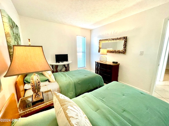 bedroom with tile patterned floors and a textured ceiling