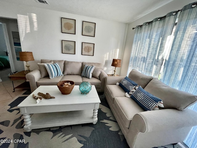 tiled living room with a textured ceiling