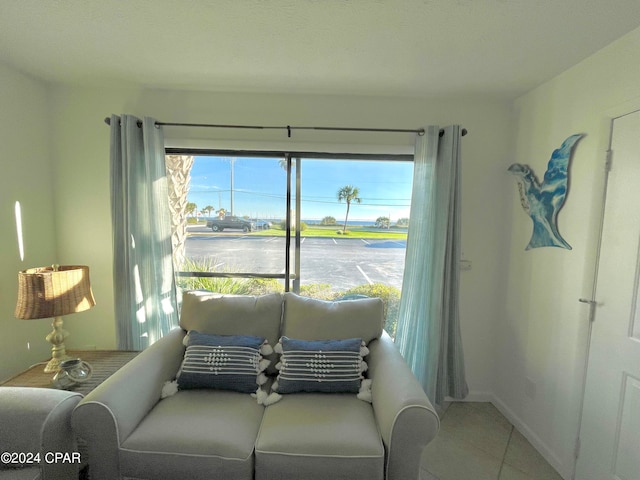 tiled living room with a water view