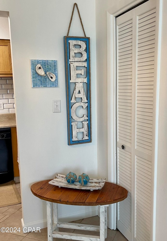 room details featuring decorative backsplash, dishwasher, and tile patterned flooring