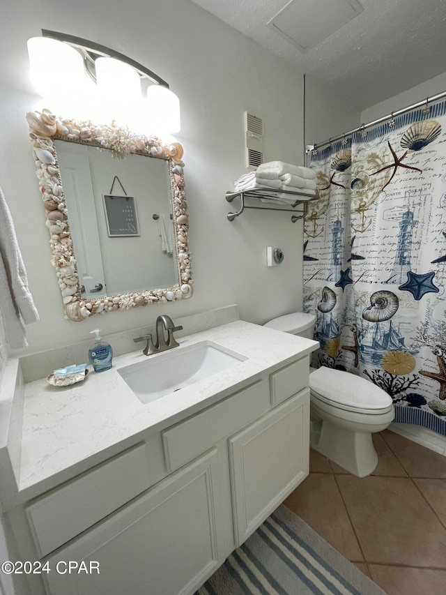 bathroom featuring toilet, tile patterned flooring, a shower with shower curtain, vanity, and a textured ceiling