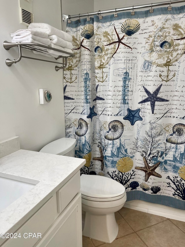 bathroom with walk in shower, vanity, toilet, and tile patterned floors