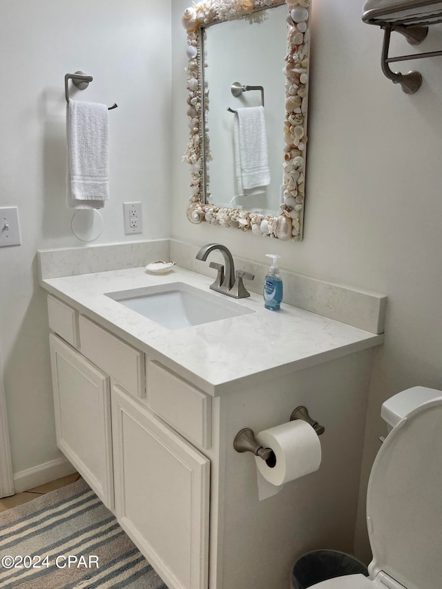 bathroom featuring vanity and toilet