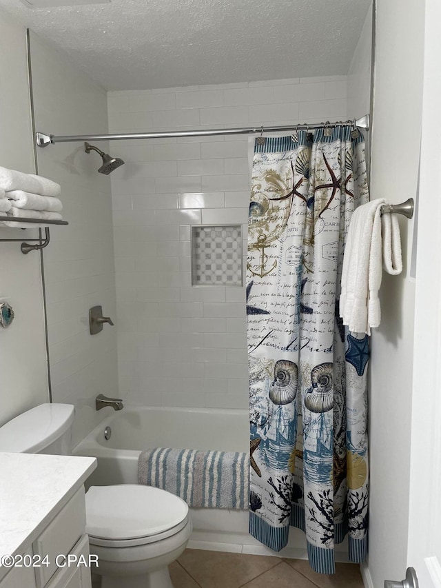 full bathroom with a textured ceiling, toilet, tile patterned floors, vanity, and shower / bathtub combination with curtain