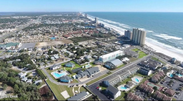 drone / aerial view with a water view and a beach view