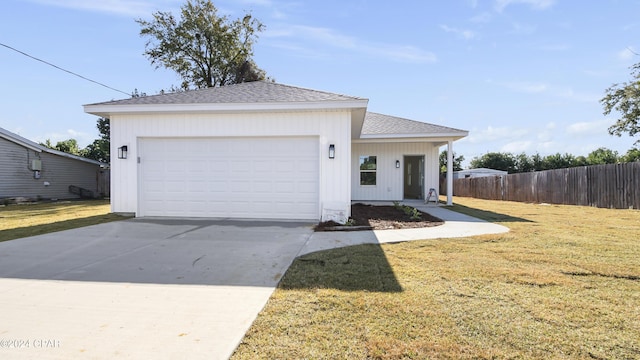 view of front of home with a front yard and a garage