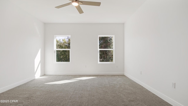 unfurnished room with baseboards, carpet, and a ceiling fan
