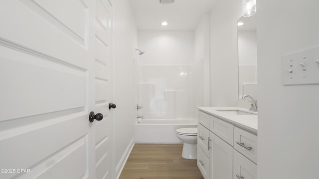 full bath with toilet, shower / tub combination, wood finished floors, recessed lighting, and vanity