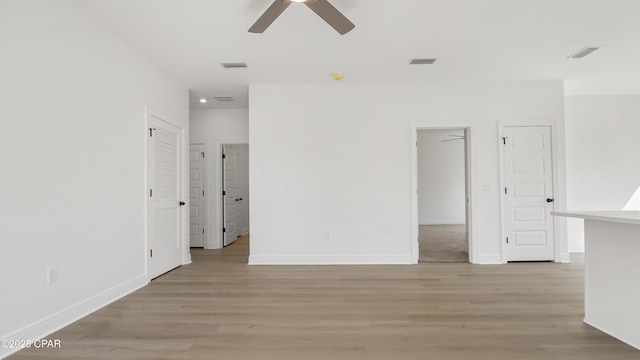 unfurnished room with visible vents, ceiling fan, and light wood finished floors