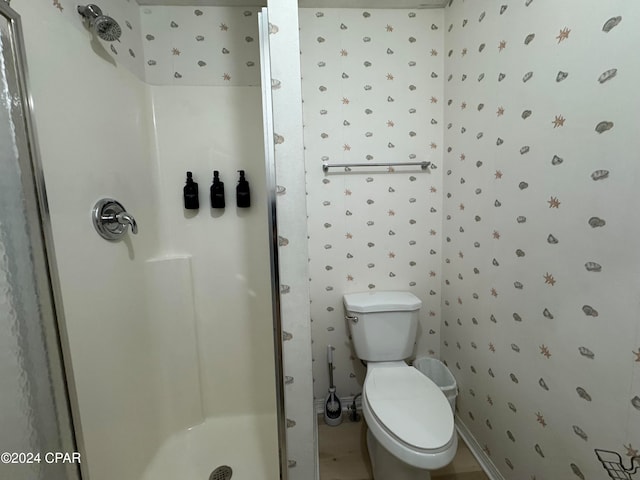 bathroom with toilet and walk in shower