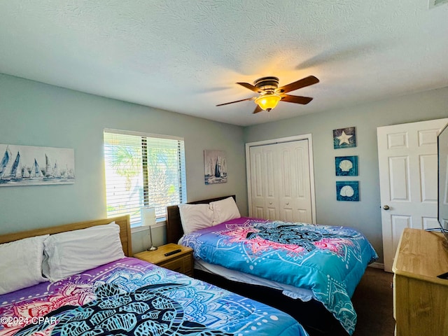 bedroom with a textured ceiling, a closet, and ceiling fan