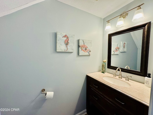 bathroom with vanity and a textured ceiling