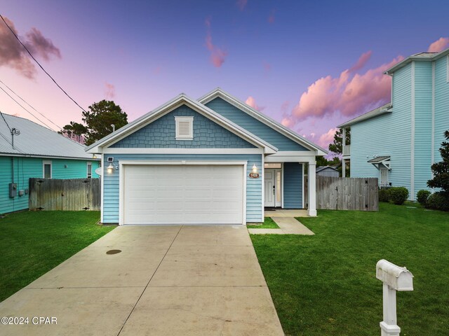 view of front of house featuring a lawn and a garage