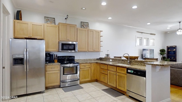 kitchen with stainless steel appliances, light stone counters, kitchen peninsula, sink, and crown molding