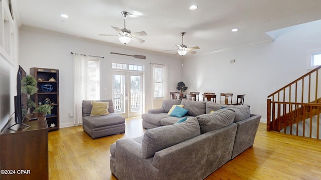 living room with light wood-type flooring, ceiling fan, and crown molding