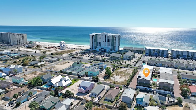 birds eye view of property with a water view and a beach view