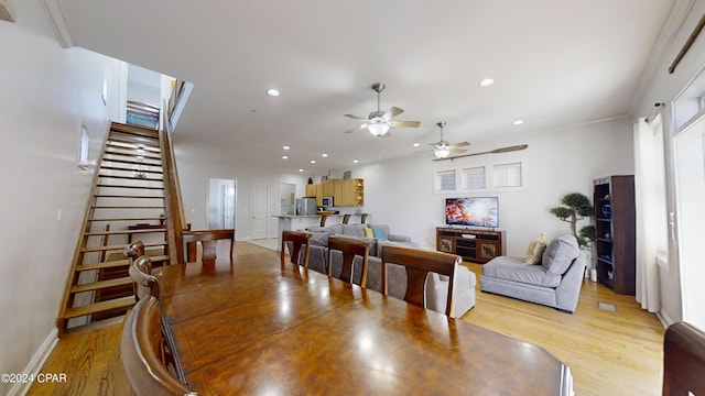 dining room featuring light hardwood / wood-style flooring, ceiling fan, and crown molding