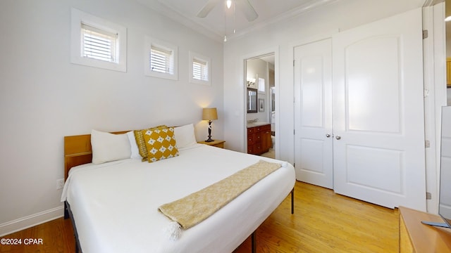 bedroom with connected bathroom, light wood-type flooring, ceiling fan, and crown molding