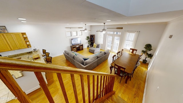 living room featuring wood-type flooring, vaulted ceiling, ceiling fan, and french doors