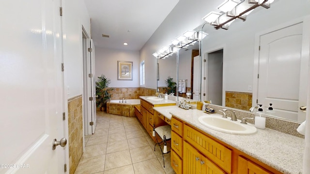 bathroom with vanity, tiled bath, and tile patterned floors