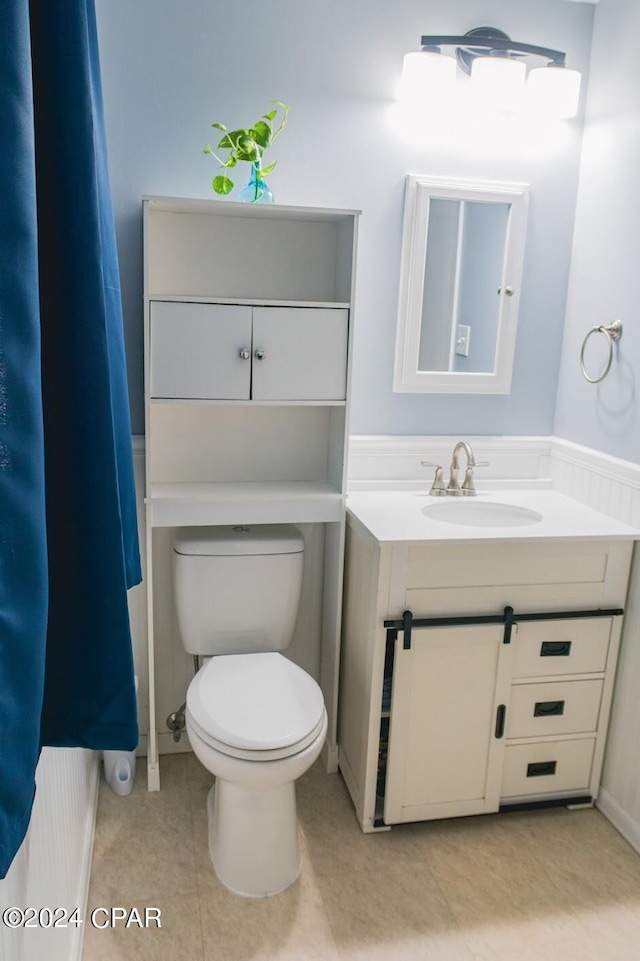 bathroom with vanity, toilet, and tile patterned flooring