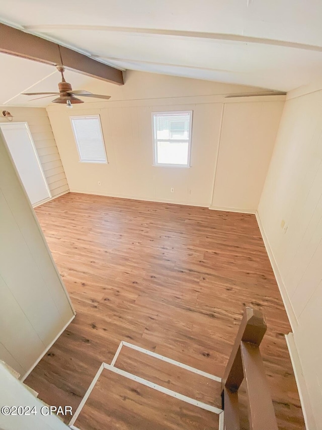 interior space featuring lofted ceiling with beams, wood finished floors, and a ceiling fan