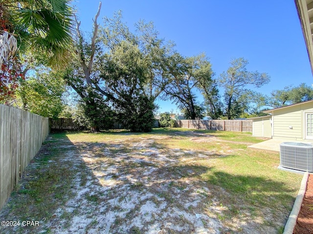 view of yard featuring central air condition unit and a fenced backyard