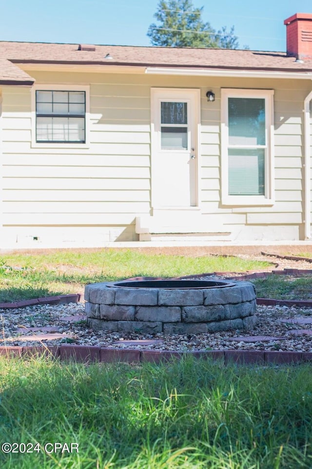 view of front of home with crawl space and a chimney