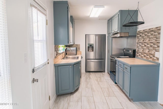 kitchen featuring decorative backsplash, black electric range, range hood, stainless steel refrigerator with ice dispenser, and sink