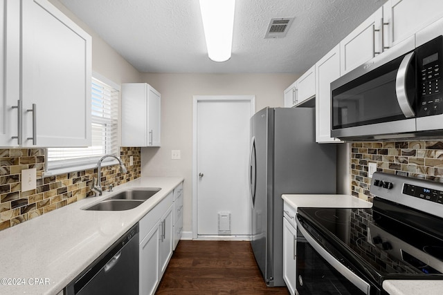 kitchen featuring sink, white cabinetry, stainless steel appliances, and dark hardwood / wood-style flooring