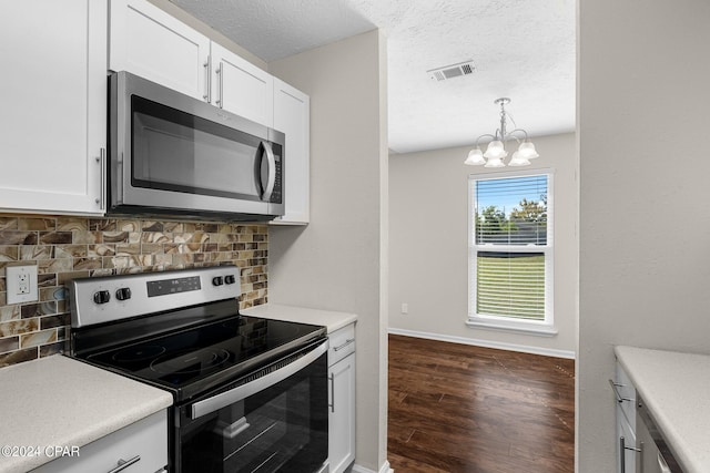 kitchen featuring white cabinetry, backsplash, appliances with stainless steel finishes, and dark wood-type flooring