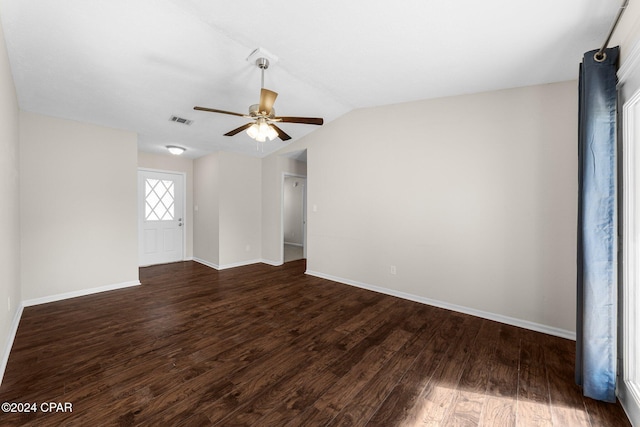 empty room with dark wood-type flooring, vaulted ceiling, and ceiling fan